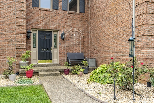 doorway to property featuring brick siding