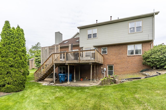 rear view of property with brick siding, a deck, a yard, and stairs
