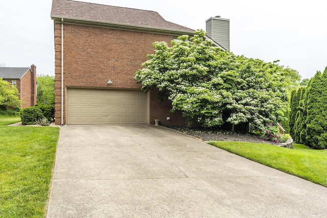 4120 Amberwood Ct, Lexington, KY 40513 - view of front of home with an attached garage, brick siding, concrete driveway, and a front lawn