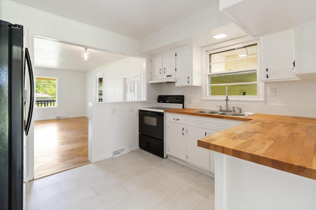 6362 E Laurel Rd, London, KY 40741 - kitchen with range with electric stovetop, freestanding refrigerator, under cabinet range hood, a sink, and white cabinetry