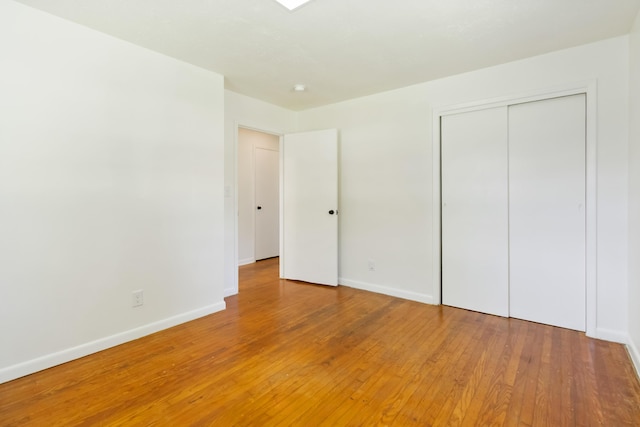 6362 E Laurel Rd, London, KY 40741 - unfurnished bedroom with light wood-type flooring, baseboards, and a closet