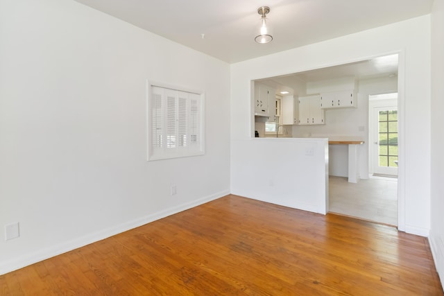 6362 E Laurel Rd, London, KY 40741 - empty room featuring light wood finished floors, baseboards, and a sink