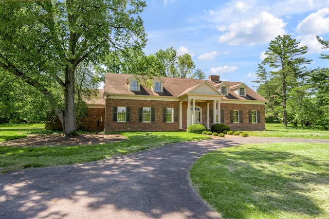 1373 Delong Cir, Lexington, KY 40515 - view of front of house featuring a chimney, a front yard, brick siding, and curved driveway