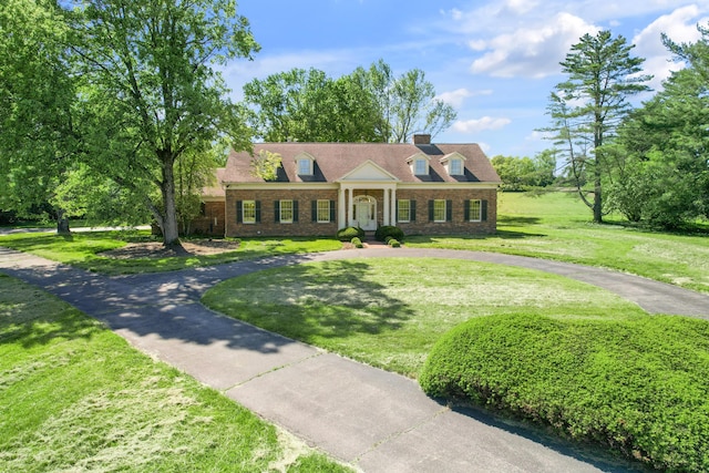 1373 Delong Cir, Lexington, KY 40515 - greek revival inspired property featuring a front yard, a chimney, and brick siding