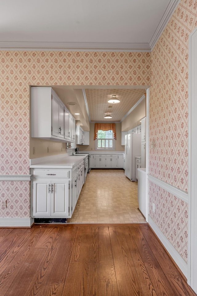 1373 Delong Cir, Lexington, KY 40515 - kitchen with wallpapered walls, ornamental molding, light countertops, baseboards, and freestanding refrigerator