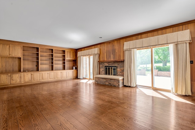 1373 Delong Cir, Lexington, KY 40515 - unfurnished living room with healthy amount of natural light, dark wood-style floors, wooden walls, and a fireplace