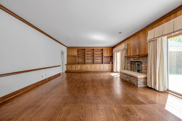 1373 Delong Cir, Lexington, KY 40515 - unfurnished living room with built in shelves, a fireplace, dark wood-style floors, crown molding, and baseboards