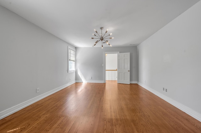 1373 Delong Cir, Lexington, KY 40515 - unfurnished room featuring a chandelier, wood finished floors, and baseboards