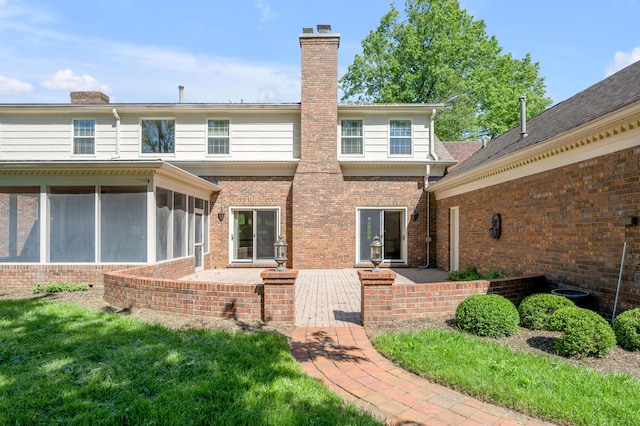 1373 Delong Cir, Lexington, KY 40515 - back of property featuring brick siding, a chimney, a sunroom, and a patio