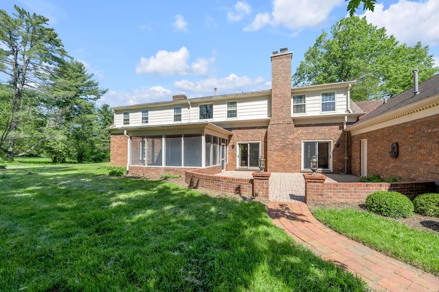 1373 Delong Cir, Lexington, KY 40515 - back of property featuring a chimney, brick siding, a sunroom, and a lawn