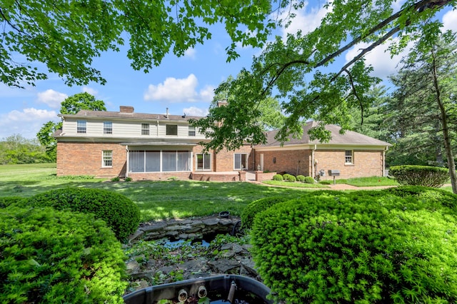 1373 Delong Cir, Lexington, KY 40515 - back of property featuring brick siding, a sunroom, a yard, and a chimney