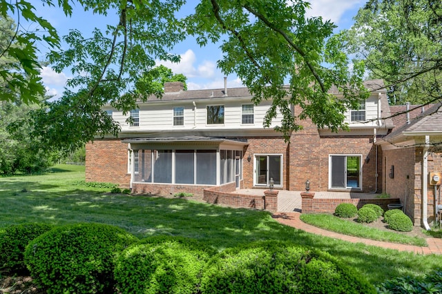 1373 Delong Cir, Lexington, KY 40515 - back of property featuring brick siding, a sunroom, a chimney, and a lawn
