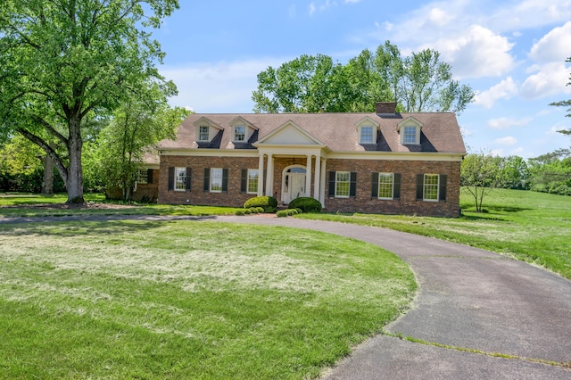 1373 Delong Cir, Lexington, KY 40515 - view of front facade with a front lawn, a chimney, brick siding, and curved driveway
