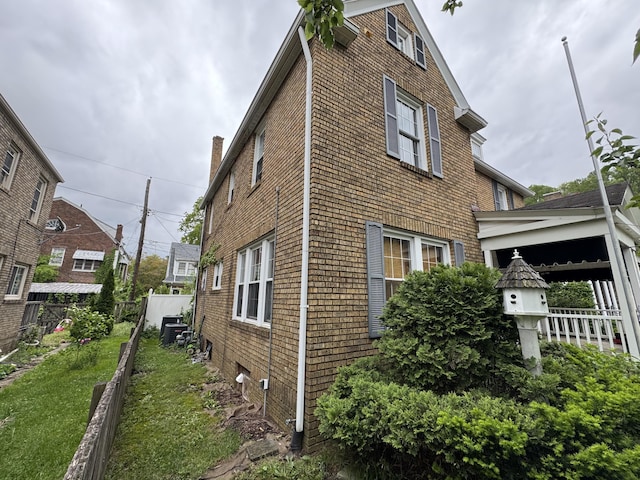 808 Windsor Ct, Ashland, KY 41101 - view of side of property featuring fence, central AC unit, and brick siding