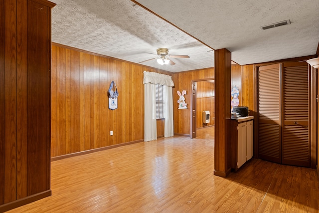 256 Park Lakes Dr, Richmond, KY 40475 - unfurnished living room with ceiling fan, wood finished floors, a textured ceiling, wooden walls, and heating unit