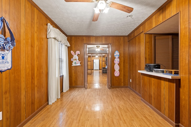 256 Park Lakes Dr, Richmond, KY 40475 - hallway with light wood-style floors, a textured ceiling, crown molding, wood walls, and baseboards