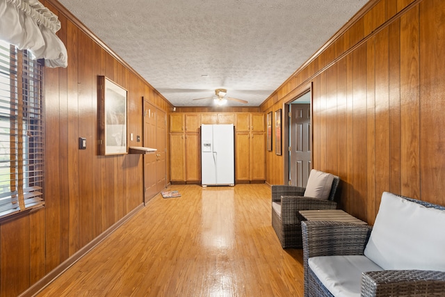 256 Park Lakes Dr, Richmond, KY 40475 - sitting room featuring light wood-type flooring, wooden walls, ceiling fan, a textured ceiling, and crown molding