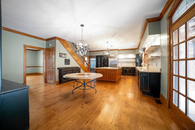 319 Fifth St, Paintsville, KY 41240 - kitchen with a chandelier, light countertops, open shelves, crown molding, and light wood finished floors