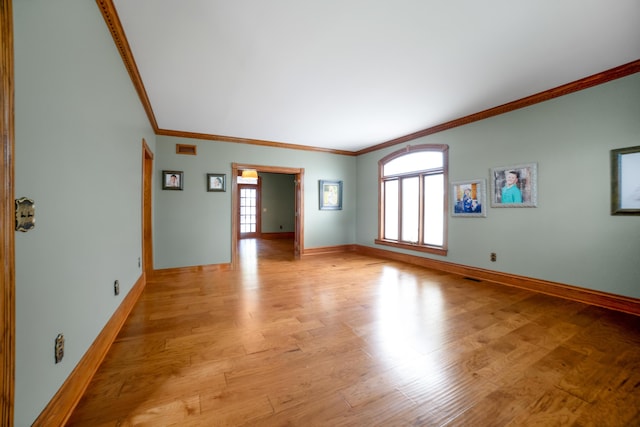 319 Fifth St, Paintsville, KY 41240 - unfurnished living room featuring crown molding, light wood-style floors, and baseboards