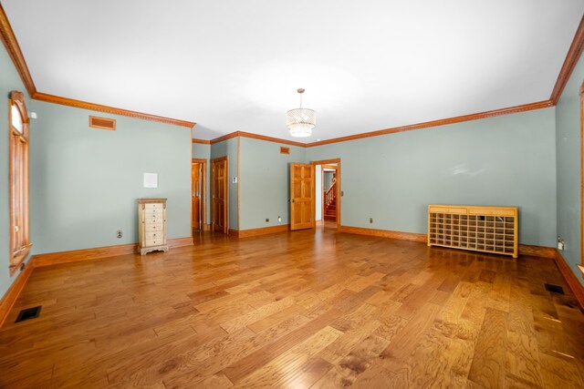 319 Fifth St, Paintsville, KY 41240 - spare room featuring wood finished floors, ornamental molding, baseboards, and a chandelier