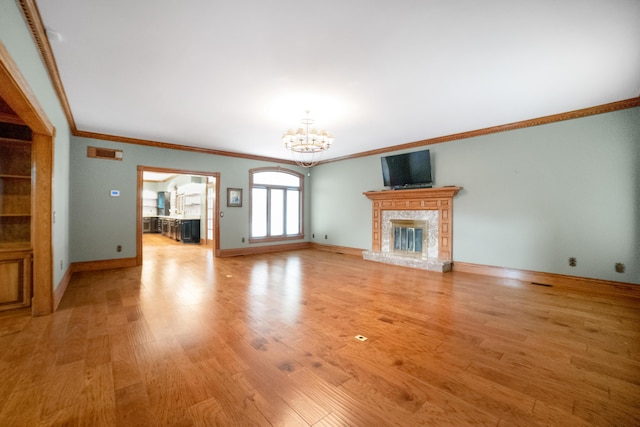 319 Fifth St, Paintsville, KY 41240 - unfurnished living room featuring a chandelier, crown molding, light wood finished floors, baseboards, and a fireplace