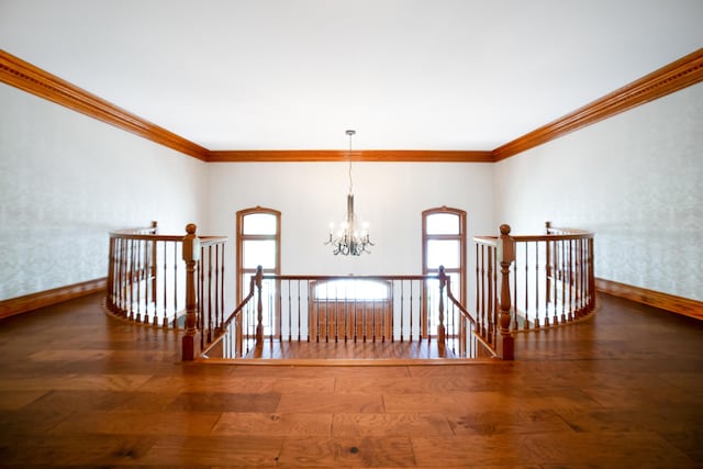 319 Fifth St, Paintsville, KY 41240 - corridor featuring an upstairs landing, a chandelier, ornamental molding, baseboards, and plenty of natural light