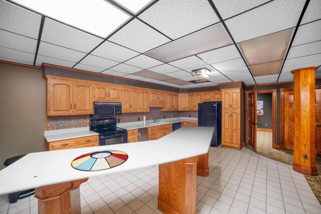 319 Fifth St, Paintsville, KY 41240 - kitchen featuring black appliances, a sink, a center island, light countertops, and a kitchen breakfast bar