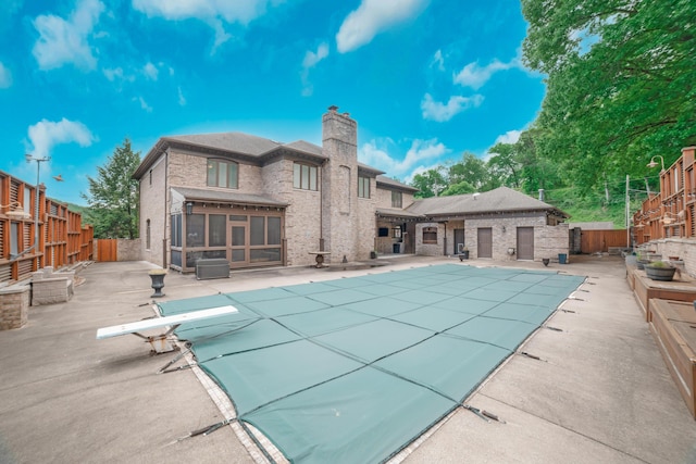 319 Fifth St, Paintsville, KY 41240 - view of swimming pool with a sunroom, a patio, a diving board, and a fenced backyard