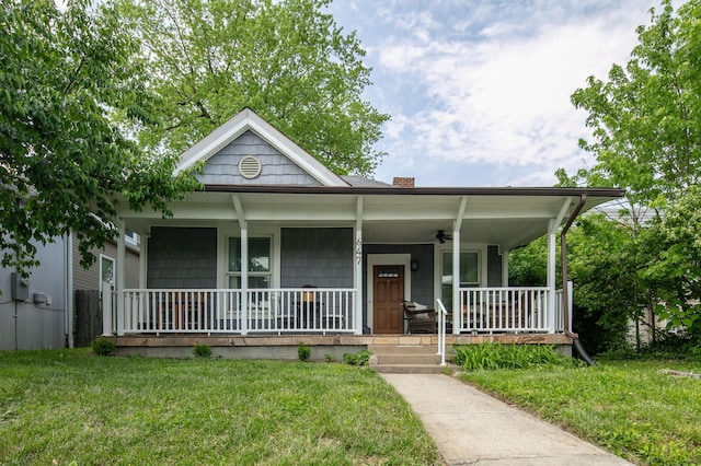 647 N Limestone, Lexington, KY 40508 - view of front facade with covered porch, a chimney, and a front lawn