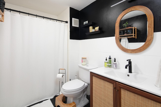 647 N Limestone, Lexington, KY 40508 - full bathroom featuring toilet, vanity, and tile walls
