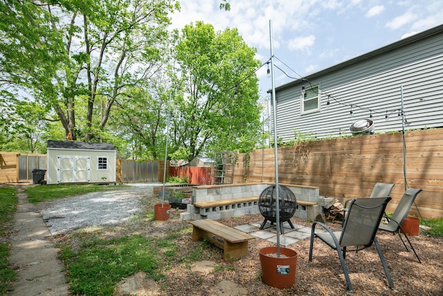 647 N Limestone, Lexington, KY 40508 - fenced backyard with a fire pit, a storage shed, and an outbuilding