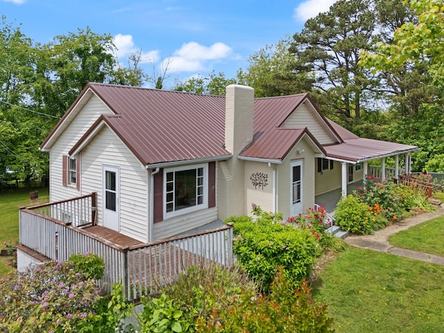 3131 Lily Rd, London, KY 40744 - view of front of house featuring a chimney, metal roof, a front lawn, and covered porch