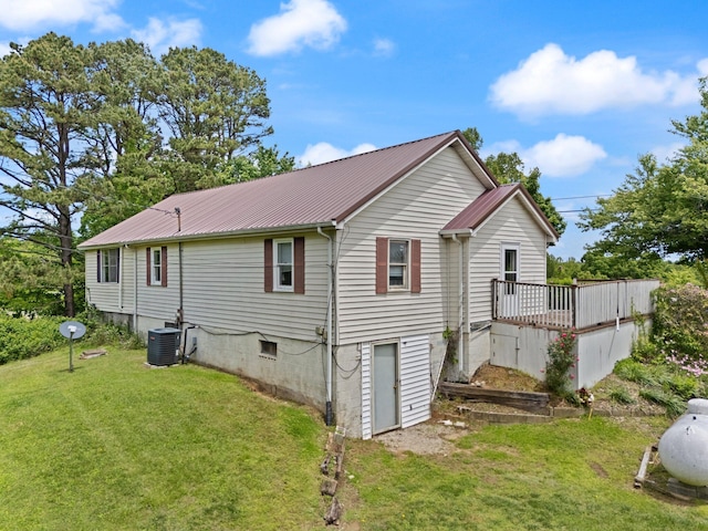 3131 Lily Rd, London, KY 40744 - back of property with metal roof, a lawn, a wooden deck, and central air condition unit