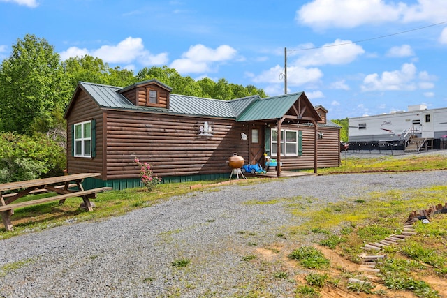 266 Boaters Aly, Nancy, KY 42544 - view of front of property with metal roof, faux log siding, and gravel driveway