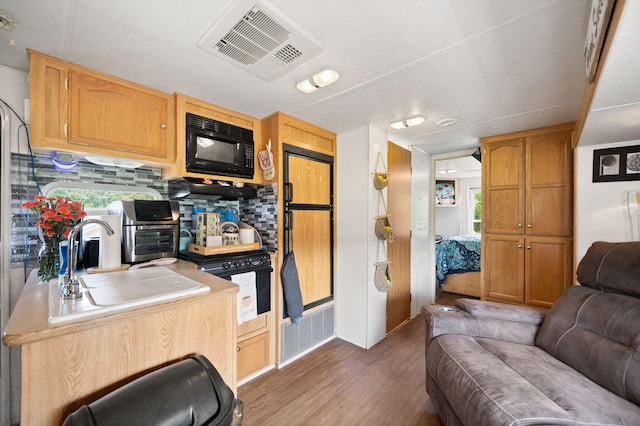 266 Boaters Aly, Nancy, KY 42544 - kitchen featuring black microwave, open floor plan, dark wood finished floors, a sink, and decorative backsplash