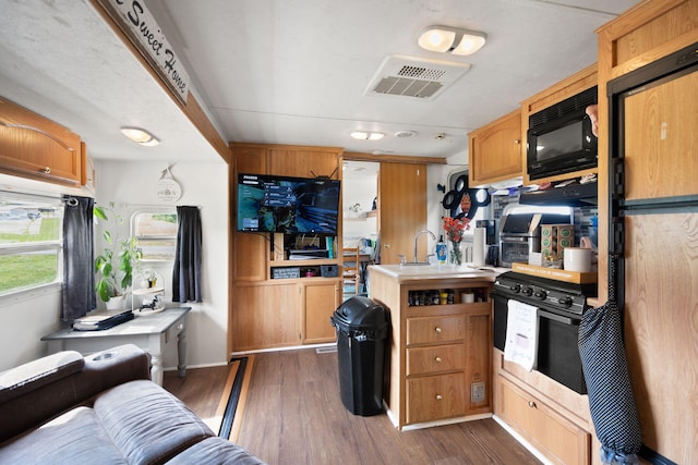 266 Boaters Aly, Nancy, KY 42544 - kitchen featuring black microwave, light countertops, dark wood finished floors, and a peninsula