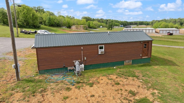 266 Boaters Aly, Nancy, KY 42544 - view of side of home with faux log siding, a lawn, metal roof, and view of wooded area