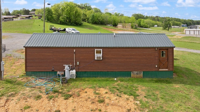 266 Boaters Aly, Nancy, KY 42544 - view of property exterior with log veneer siding, a lawn, an outbuilding, and metal roof