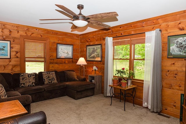 1220 Fox Wood Rd, Frankfort, KY 40601 - carpeted living area featuring healthy amount of natural light, wood walls, and a ceiling fan