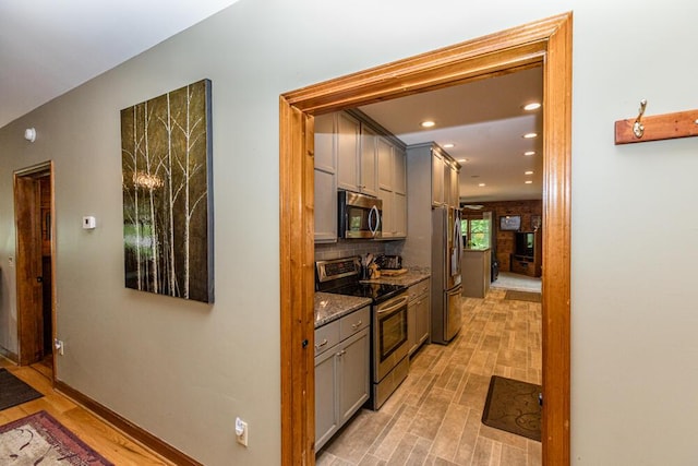1220 Fox Wood Rd, Frankfort, KY 40601 - kitchen featuring stainless steel appliances, gray cabinetry, light wood-style flooring, dark stone countertops, and recessed lighting