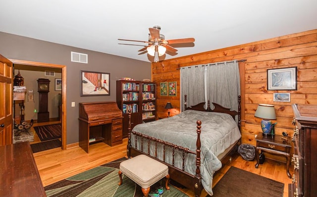 1220 Fox Wood Rd, Frankfort, KY 40601 - bedroom featuring multiple windows, wood finished floors, wood walls, and a ceiling fan