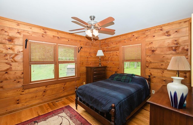 1220 Fox Wood Rd, Frankfort, KY 40601 - bedroom featuring multiple windows, wood finished floors, wood walls, and a ceiling fan