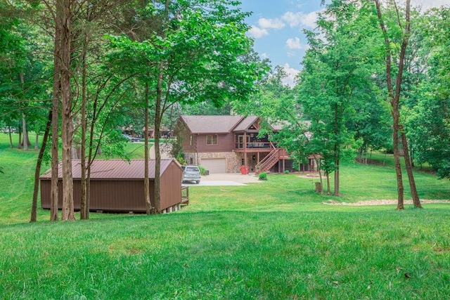1220 Fox Wood Rd, Frankfort, KY 40601 - view of green lawn featuring an attached garage, stairway, a wooden deck, concrete driveway, and an outdoor structure