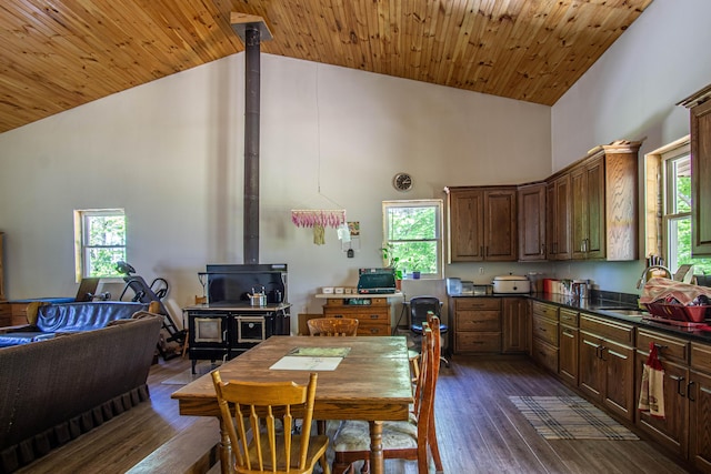 227 Callihan Rd, East Bernstadt, KY 40729 - dining space with high vaulted ceiling, a wood stove, dark wood-style flooring, plenty of natural light, and wood ceiling
