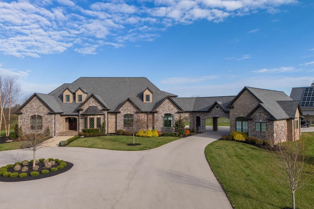 1782 W Leestown Rd, Midway, KY 40347 - french country home featuring curved driveway, a front yard, stone siding, and brick siding