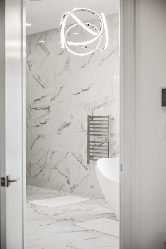 1782 W Leestown Rd, Midway, KY 40347 - bathroom featuring a towel warmer, a chandelier, a marble finish shower, and marble tiled floors