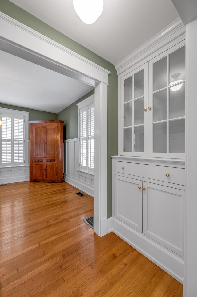 133 Victory Ave, Lexington, KY 40502 - unfurnished room featuring light wood-type flooring, a wainscoted wall, and a decorative wall