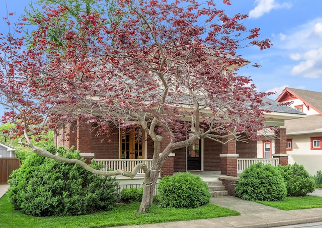 133 Victory Ave, Lexington, KY 40502 - obstructed view of property featuring a porch and brick siding