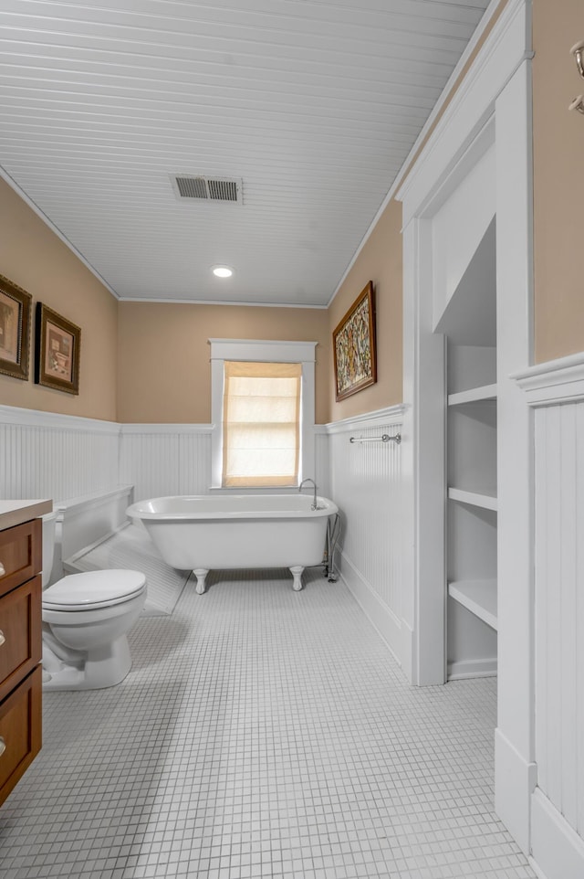 133 Victory Ave, Lexington, KY 40502 - full bathroom with a wainscoted wall, toilet, a soaking tub, vanity, and ornamental molding