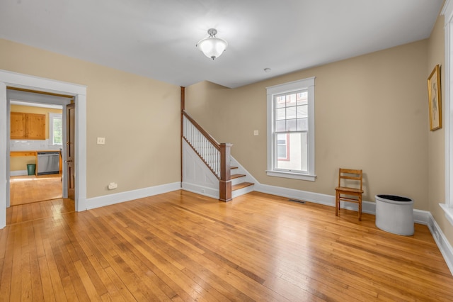 133 Victory Ave, Lexington, KY 40502 - spare room with stairway, light wood-type flooring, baseboards, and healthy amount of natural light